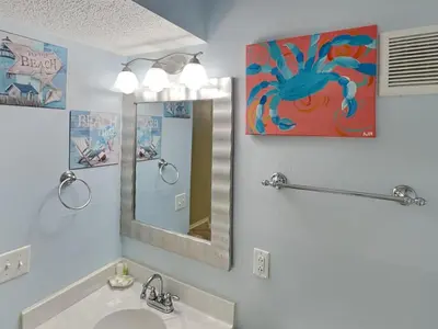 a bathroom with a sink and a mirror at Summit Beach Resort #326 in Panama City Beach