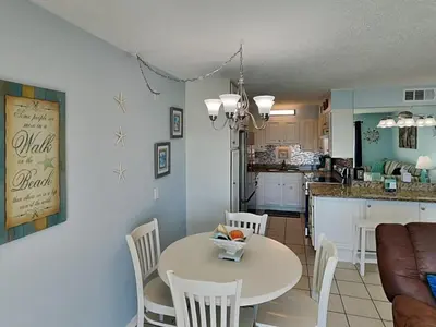 a kitchen and living room with a table and chairs at Summit Beach Resort #326 in Panama City Beach