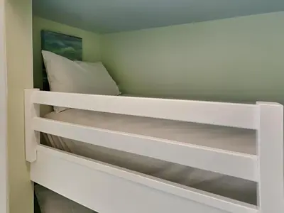 a white bunk bed in a small room at Summit Beach Resort #326 in Panama City Beach