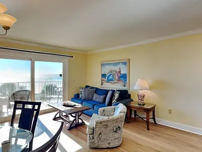 a living room with a blue couch and a table at Summit Beach Resort #429 in Panama City Beach