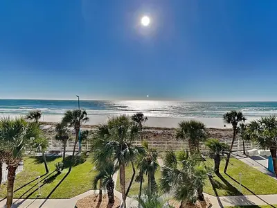 a view of a beach with palm trees and the moon at Summit Beach Resort #429 in Panama City Beach