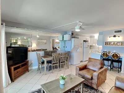 a living room with a kitchen and a dining room at Summit Beach Resort 604 in Panama City Beach