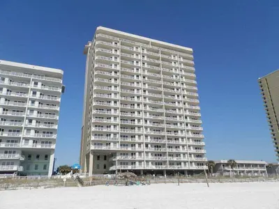 a large apartment building on the beach next to the ocean at Grandview East #104 in Panama City Beach