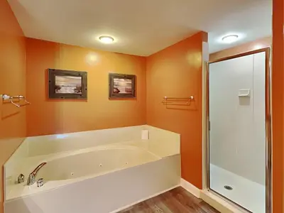 a bathroom with a large tub and a shower at Grandview East #104 in Panama City Beach