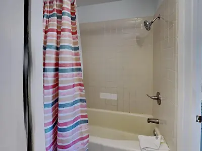 a bathroom with a tub and a shower curtain at Summit Beach Resort #526 in Panama City Beach