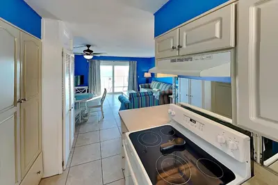 a kitchen with blue walls and a stove top oven at Summit Beach Resort in Panama City Beach
