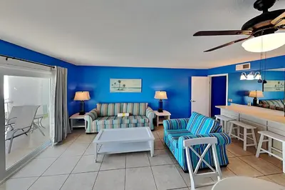 a living room with a couch and a table at Summit Beach Resort in Panama City Beach
