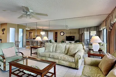 a living room with a couch and a table at Edgewater Villa 1307 in Panama City Beach