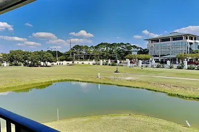 a view of a golf course with a pond at Edgewater Villa 1307 in Panama City Beach