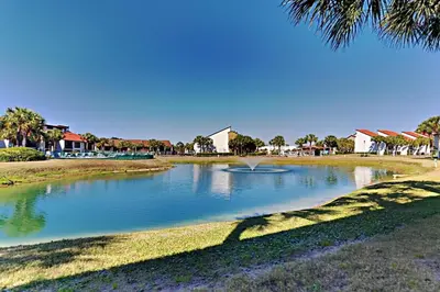 a pond with a fountain in the middle of a park at Edgewater Villa 1001 in Panama City Beach