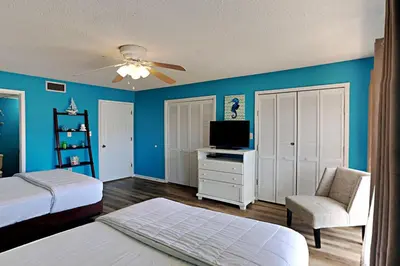 a bedroom with two beds and a ceiling fan at Edgewater Villa 1001 in Panama City Beach