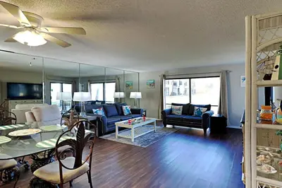 a living room with a couch and a table at Edgewater Villa 1001 in Panama City Beach