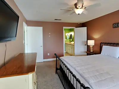 a bedroom with a bed and a flat screen tv at Edgewater Villa 1312 in Panama City Beach