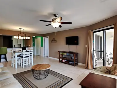 a living room with a couch and a ceiling fan at Edgewater Villa 1312 in Panama City Beach