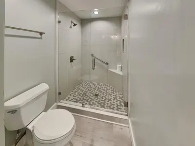 a bathroom with a toilet and a shower at Edgewater Villa 1211 in Panama City Beach