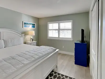 a bedroom with a bed and a television in it at Edgewater Villa 1211 in Panama City Beach