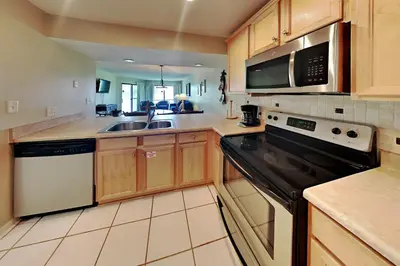 a kitchen with a sink and a stove top oven at Edgewater Villa 1410 in Panama City Beach