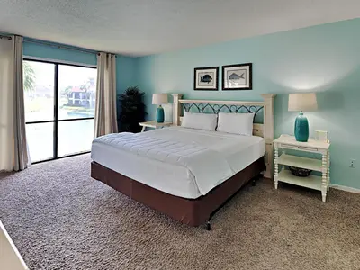 a bedroom with a large bed and a large window at Edgewater Villa 1509 in Panama City Beach