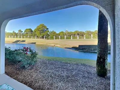 a view of a river through a window at Edgewater Villa 1702 in Panama City Beach