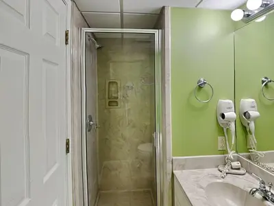 a bathroom with a shower and a sink at Edgewater Villa 1702 in Panama City Beach