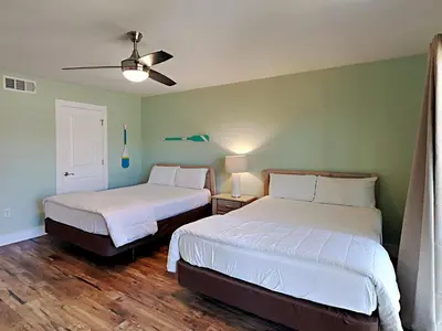 a bedroom with two beds and a ceiling fan at Edgewater Villa #2406 in Panama City Beach