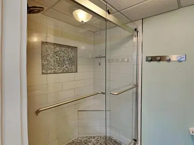 a glass shower stall with a glass door at Edgewater Villa #2406 in Panama City Beach