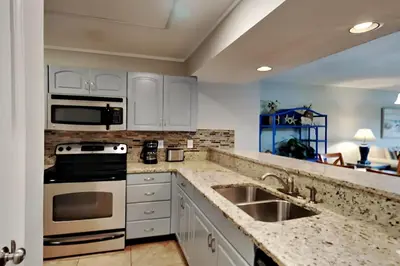 a kitchen with a sink and a stove at Edgewater Villa #2301 in Panama City Beach
