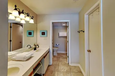 a bathroom with two sinks and a toilet at Edgewater Villa #2407 in Panama City Beach