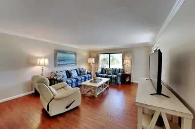 a living room with a couch and a tv at Edgewater Villa #2409 in Panama City Beach