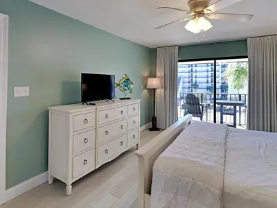 a bedroom with a white dresser with a television on it at Edgewater Villa #3315 in Panama City Beach