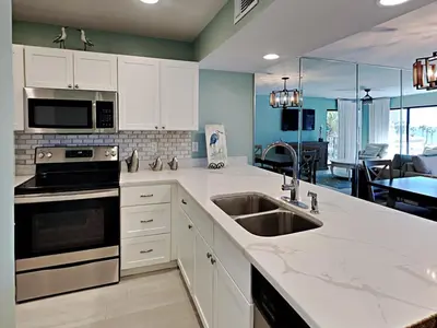 a kitchen with a sink and a stove top oven at Edgewater Villa #3315 in Panama City Beach