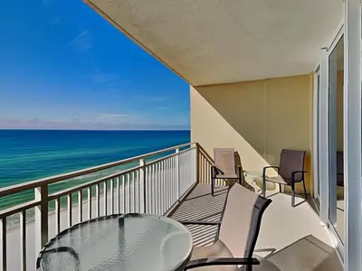 a balcony with a table and chairs and the ocean at Emerald Beach #1127 in Panama City Beach