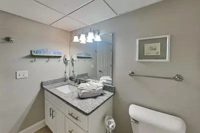 a bathroom with a sink and a mirror at Emerald Beach #1030 in Panama City Beach