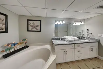a bathroom with a large tub and a sink at Emerald Beach #1030 in Panama City Beach