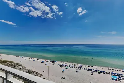 a view of a beach with umbrellas and the ocean at Emerald Beach #1030 in Panama City Beach