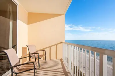 a balcony with two chairs and the ocean at Majestic Beach Towers 1-1210 in Panama City Beach