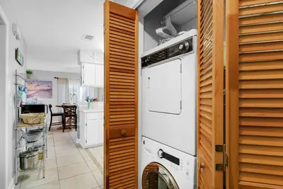 a kitchen with a washer and dryer in a room at Happy Heron, Steps to Beach in Panama City Beach
