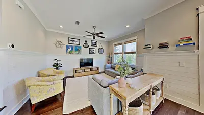 a living room with a couch and a table at The Den on 30A in Inlet Beach