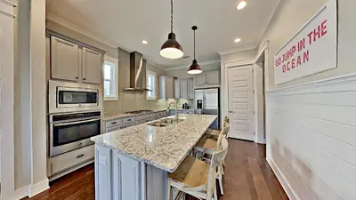 a kitchen with a large island with a counter top at The Den on 30A in Inlet Beach