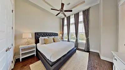a bedroom with a bed and a ceiling fan at The Den on 30A in Inlet Beach