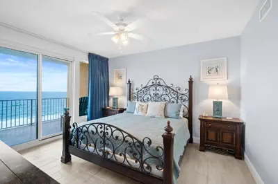 a bedroom with a bed with a view of the ocean at Quiet East End Gulf-Front Condo w/ Heated Pool & Balcony in Panama City Beach