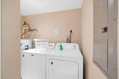 a laundry room with a washing machine and a sink at Quiet East End Gulf-Front Condo w/ Heated Pool & Balcony in Panama City Beach