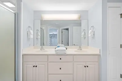 a bathroom with two sinks and a large mirror at Quiet East End Gulf-Front Condo w/ Heated Pool & Balcony in Panama City Beach