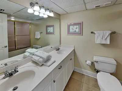 a bathroom with a sink and a toilet and a mirror at Long Beach Resort Tower II #904 in Panama City Beach