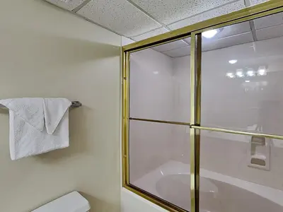 a bathroom with a glass shower and a toilet at Long Beach Resort Tower II #904 in Panama City Beach
