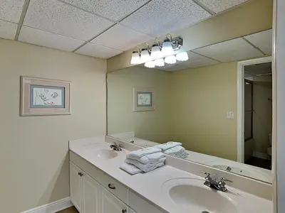 a bathroom with a sink and a large mirror at Long Beach Resort Tower II #904 in Panama City Beach