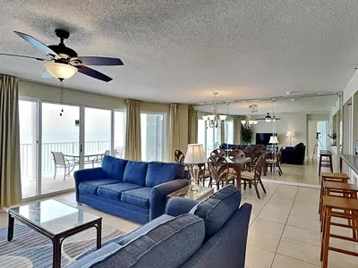 a living room with a blue couch and a table at Long Beach Resort Tower II #904 in Panama City Beach