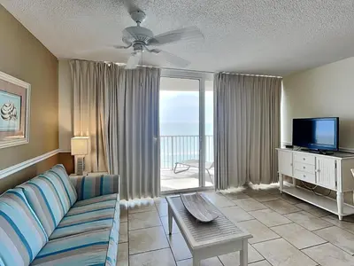 a living room with a couch and a television at Long Beach Resort Tower III #905 in Panama City Beach