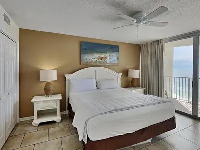 a bedroom with a bed and two night stands with lamps at Long Beach Resort Tower III #905 in Panama City Beach