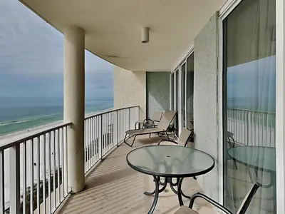 a balcony with a table and chairs and the ocean at Long Beach Resort Tower III #905 in Panama City Beach